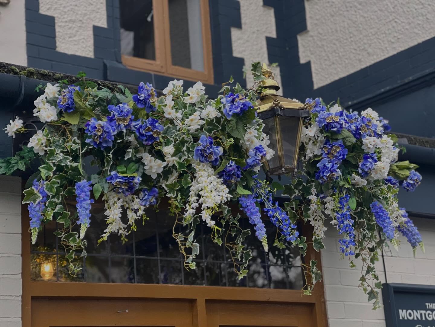 Blue and white floral installation around a traditional outdoor lantern