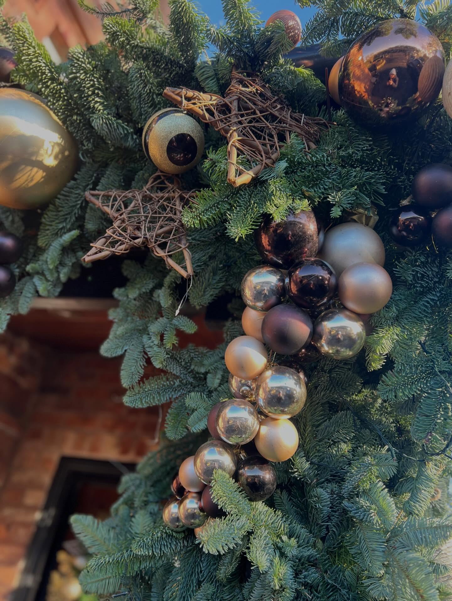 Rich red and gold Christmas foliage with berries and ribbon